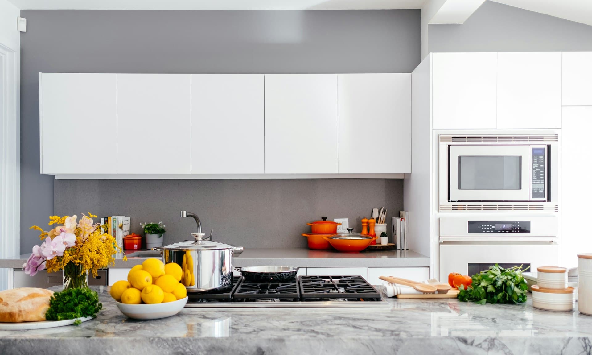 Open-concept kitchen with custom cabinetry and a large stone island